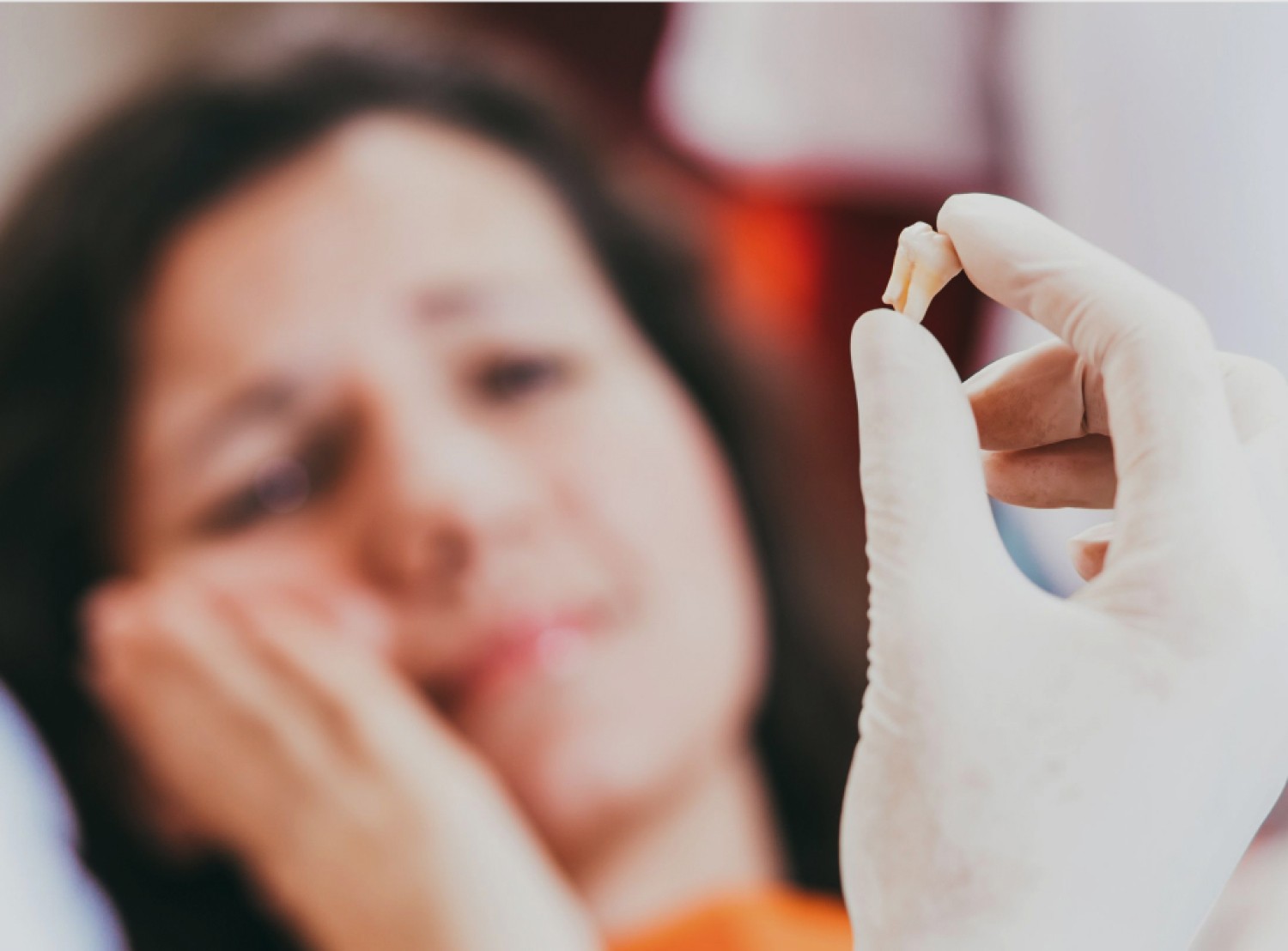 woman in pain being shown tooth