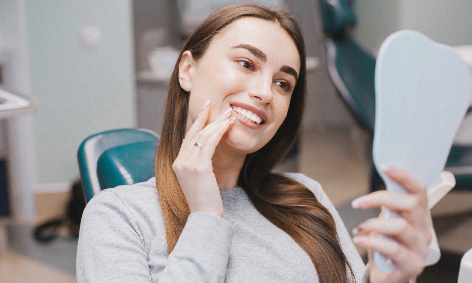 woman watching her teeth in mirror